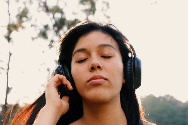 women wearing black colored headphones