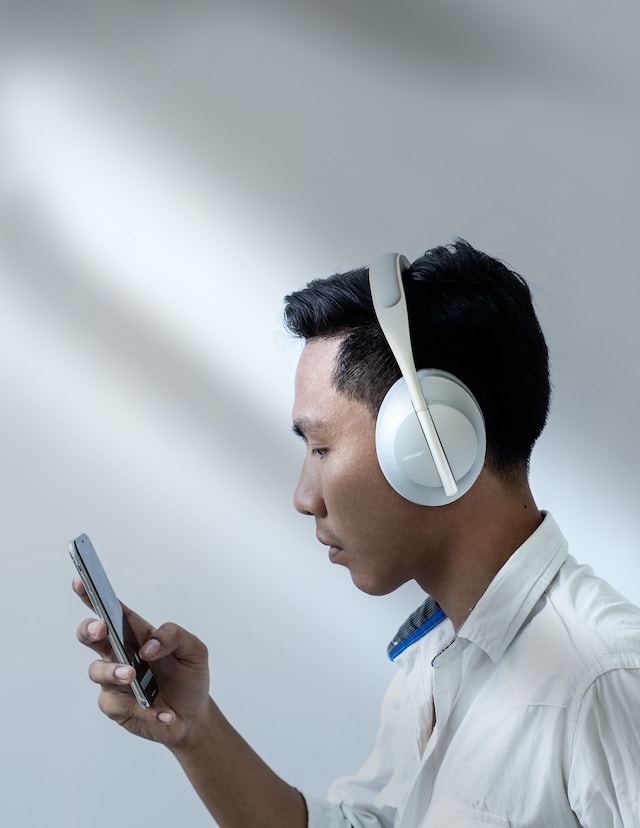 man listening music in white headphones